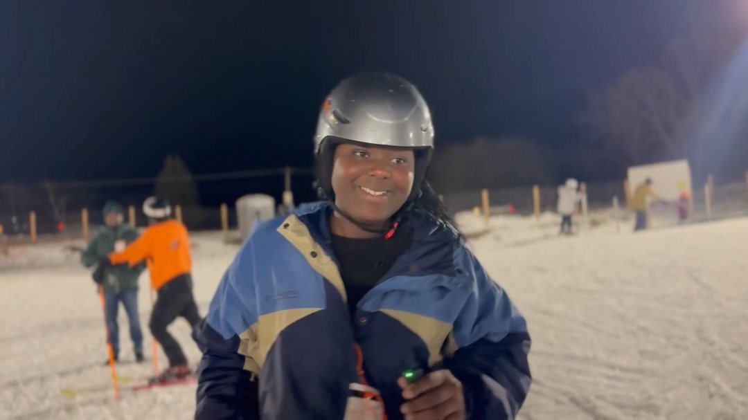 Skiers on the slope at night